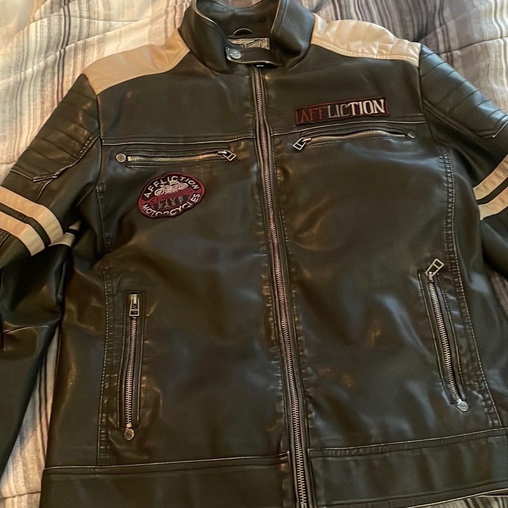 Black and grey leather jacket with some red lettering/like a motorcycle jacket